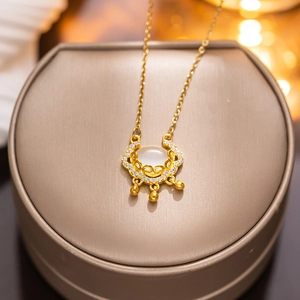 Golden necklace with white chalcedony Ruyi lock pendant on a jewelry gift box