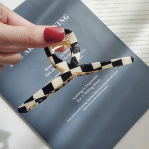 Handheld black and white checkerboard acetate hair claw clip for long hair styling