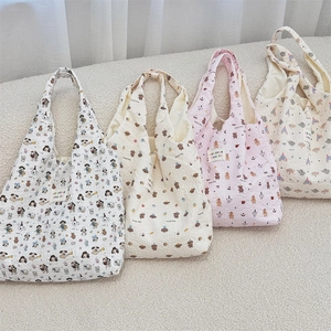 Detail of four colorful seersucker canvas tote bags with cartoon animal patterns and textures