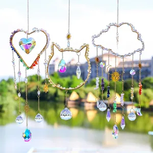 Three-piece sun catcher set with crystal stones and metal charms in a sunlit outdoor setting