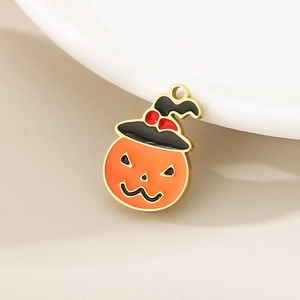 Detail of Halloween pumpkin charm with black wizard hat and orange enamel finish