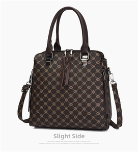 Close-up of brown handbag with gold interlocking pattern and silver hardware detail