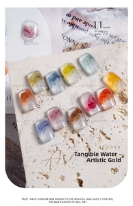 Detail showing 11 marble ink nail art designs with gold leaf accents on stone