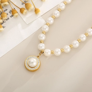 Detail of French pearl necklace with gold beads and rhinestone circular pendant