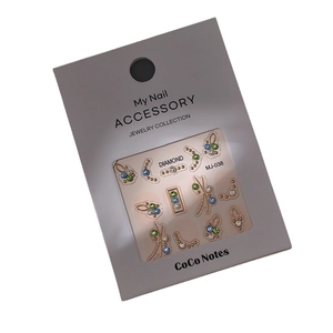 Mix of gold, blue and green nail art rhinestones with metal frames on MJ-038 card
