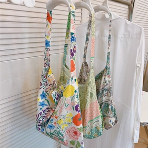 Detailed view of lightweight printed cotton tote bags with long straps and artistic patterns