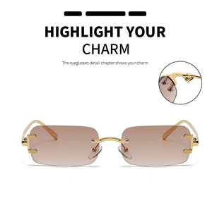 Detail of rimless rectangle sunglasses with gold C-shape hinge and brown gradient lenses