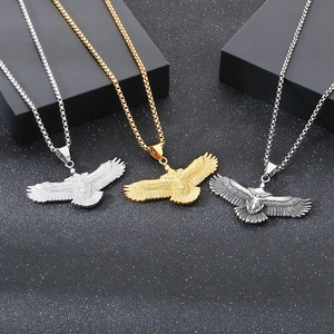Detailed close-up of eagle necklaces in silver, gold, and antique finishes on a dark base