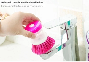 Detail view of pink automatic liquid dispensing pot brush with handheld press button design