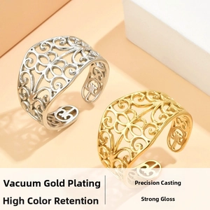 Detailed close-up of vintage hollow floral pattern gold and silver stainless steel rings
