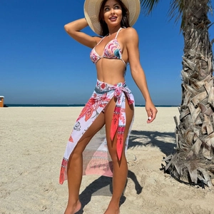 Three-piece floral print bikini set with halter top and matching sarong skirt beachwear
