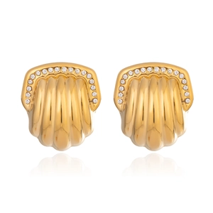 Macro detail of gold fan-shaped stud earrings with sparkling crystal accents