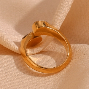 Detailed view of 18K gold plated stainless steel ring with double water drop design on silk