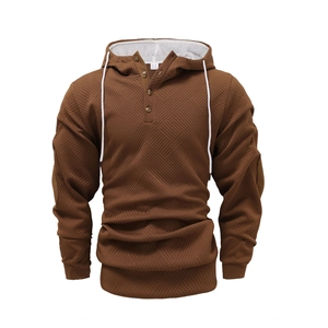 Macro detail of men's brown hoodie with diamond jacquard texture and button neckline