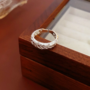Detailed view of S925 silver ring with wheat ear texture and zircon inlay on a jewelry box