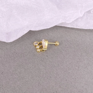Detailed view of a gold heart stud earring with diamond tassels and screw back design