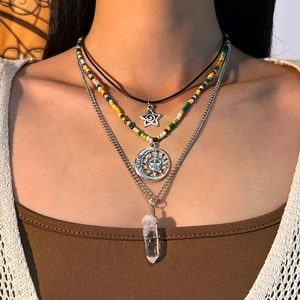 Three-layer bohemian necklace featuring crystal pendant, celestial charms, and colorful beads