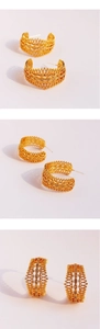 Detail of vintage gold hollow lace hoop earrings with inlaid sparkling zircon crystals
