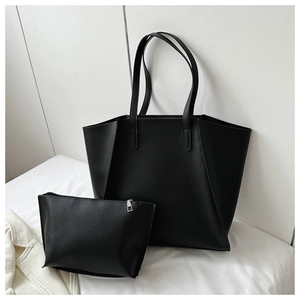 Detail of a large black faux leather tote bag set including a matching zipper pouch