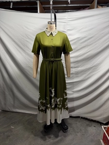 Detail view of olive green maxi dress featuring a printed collar, short sleeves, and belt