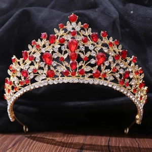 Macro shot of luxury red crystal bridal tiara with gold alloy and leaf motif details