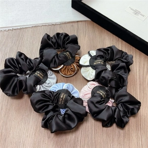 Five-pack of satin camellia scrunchies with elegant double-layered color contrast