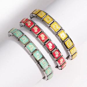 Close-up of enamel zodiac charms on stainless steel modular Italian bracelets