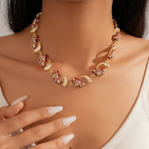 Detailed close-up of vintage flower necklace with red enamel and small white zircons