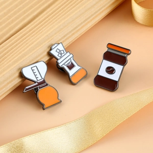 Three-piece coffee enamel pins set featuring a drip pot, filter, and storage canister