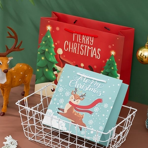 Red and blue Christmas paper gift bags with reindeer and tree patterns for holiday favors