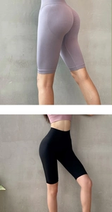 Vertical view of seamless high-waisted lifting yoga shorts in purple and black