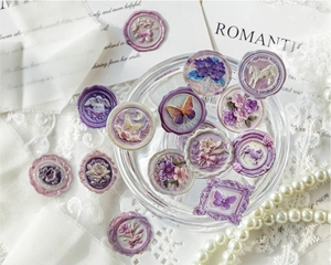 Detailed view of lavender wax seal stickers with butterfly and floral resin motifs