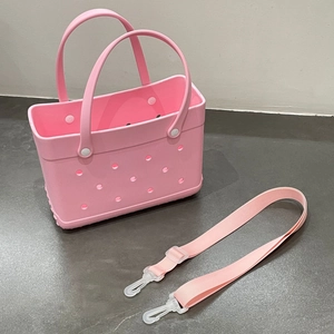 Pink EVA beach bag detail showing ventilated holes and adjustable fabric shoulder strap