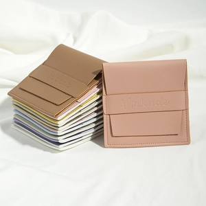 Close-up of premium PU leather jewelry pouches in various colors with debossed logo