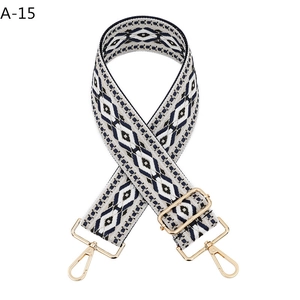 Close-up of diamond pattern jacquard strap with gold swivel hooks and metal sliders