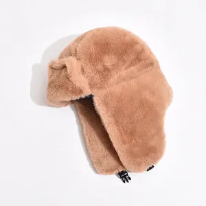 Plush camel trapper hat with faux fur lining and chin strap for winter warmth