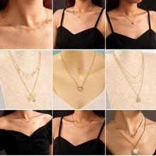 Collection of layered 925 silver and gold necklaces with butterfly and pearl pendants