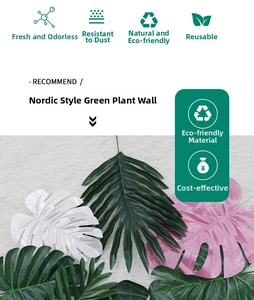 Detail of assorted faux monstera and palm leaves in green, pink, and white for decor
