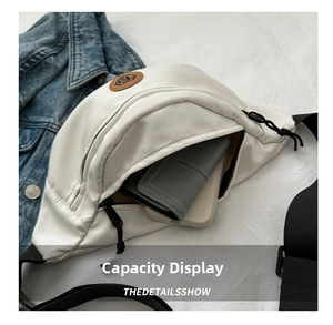 Internal view of a white nylon chest bag holding a leather wallet and smartphone