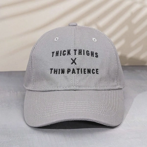 Detail of THICK embroidery on light grey washed cotton baseball cap with vintage finish