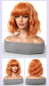 Multiple views of an orange wavy bob wig with bangs on a professional mannequin