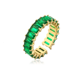 Golden open ring with green rectangular cubic zirconia in a baguette setting