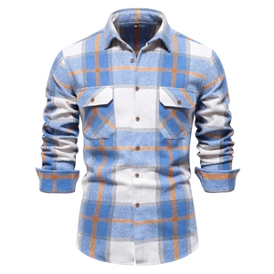 Detailed view of the blue and orange plaid flannel texture and double chest pocket design