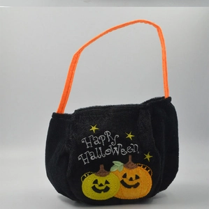 Detail of soft black velvet Halloween candy bag with orange handle and pumpkin embroidery