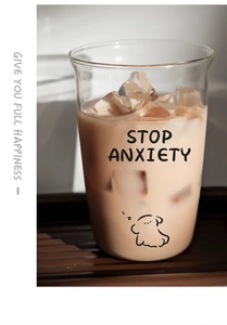 Detail of high borosilicate glass cup with STOP ANXIETY text and cartoon dog print