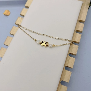 Close-up of 18K gold-plated double-layer chain bracelet with hollow butterfly and pearls