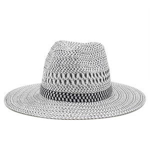 Detail of the black and white woven texture and checkered ribbon on the straw fedora hat