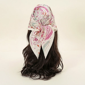 Rear view of a floral paisley satin square scarf tied elegantly on a model's head
