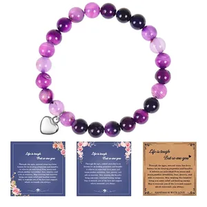 Detailed view of 8mm purple natural stone bracelet with heart charm and card
