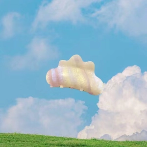 Cloud-shaped iridescent acetate hair claw clip with pink and yellow gradient stripes
